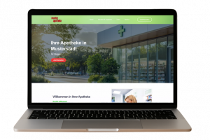 Laptop zeigt eine moderne Apotheken-Webseite mit dem Titel „Ihre Apotheke in Musterstadt“ und einem roten Button „Jetzt Bestellen“.